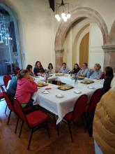Thestaff sit round a large table in the church
