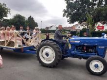 Blue tractor takes the guests from the church